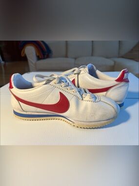 Nike White Leather Sneakers with Red Swoosh and Blue Midsole Stripe